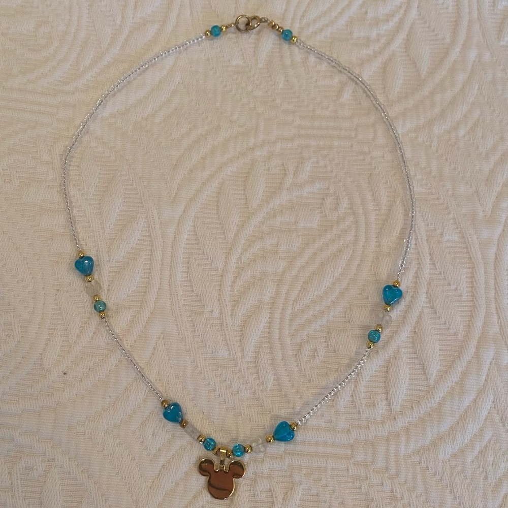 Disney necklace with gold plated Mickey and turquoise heart beading.